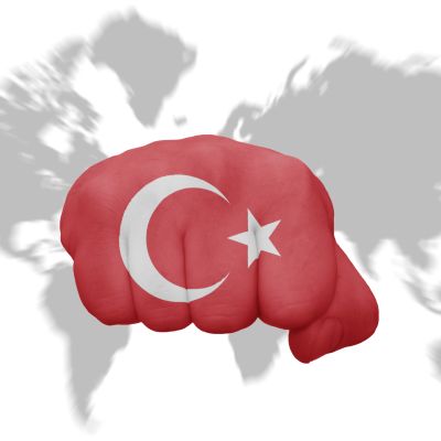 fist with the national flag of turkey on a world map background